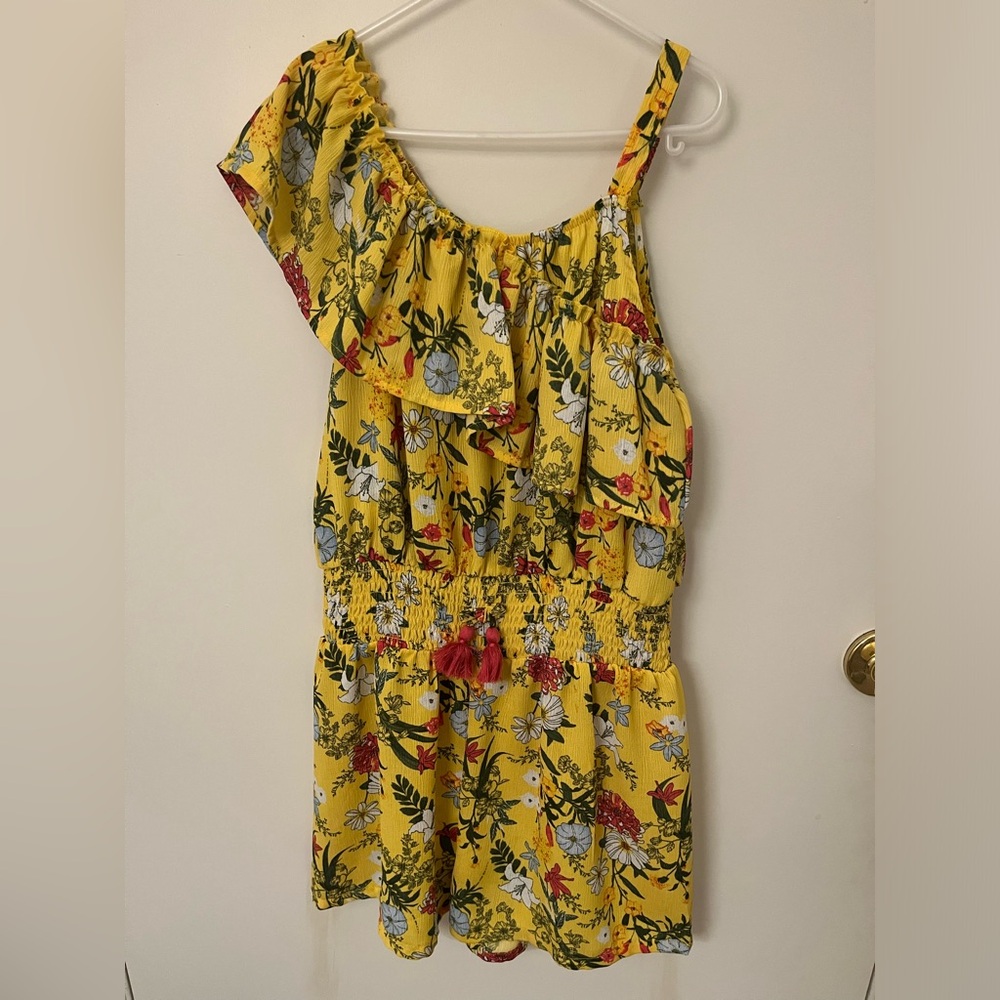 BCBGirls summer romper with mismatched strap design and pom pom’s.